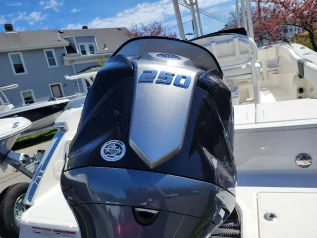 Slide: The Image of 2024 Robalo R232EX boat with a 250 horsepower engine, docked outdoors. - 5
