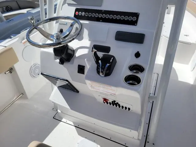 Slide: The Image of 2024 Edgewater 245CC boat console with steering wheel and controls. - 10