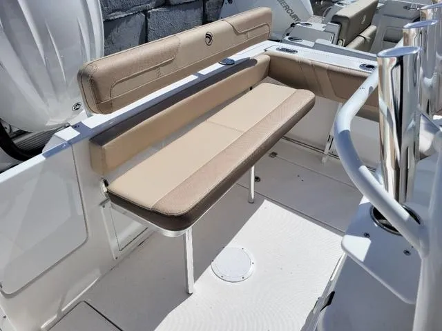 Slide: The Image of 2024 Edgewater 245CC boat interior with beige seating and modern design. - 13