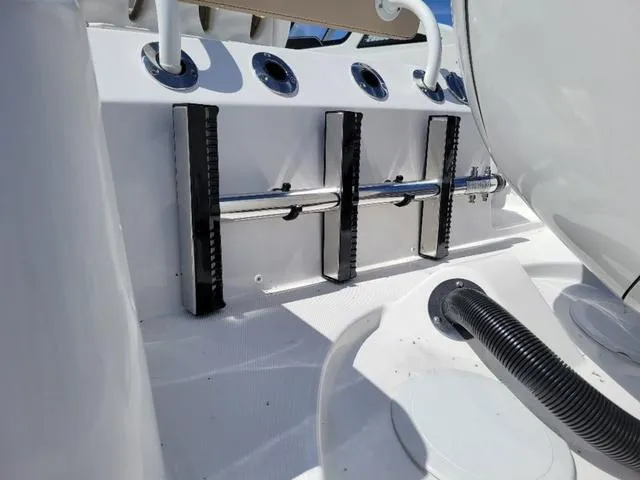 Slide: The Image of 2024 Edgewater 245CC boat interior with rod holders and sleek design. - 6