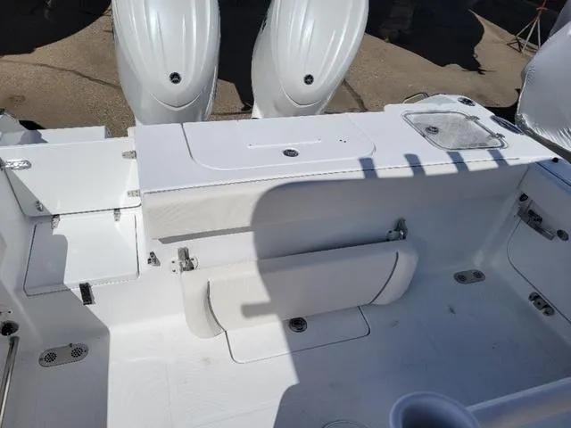 Slide: The Image of 2024 Sea Hunt Gamefish 25 boat interior with dual engines and seating area. - 10