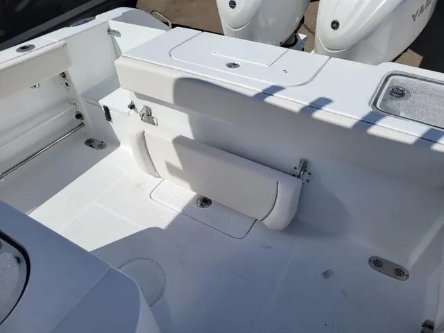 Slide: The Image of 2024 Sea Hunt Gamefish 25 boat interior with white seating and storage compartments. - 11