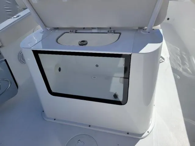 Slide: The Image of 2024 Sea Hunt Gamefish 25 livewell with open lid, showcasing interior design. - 13