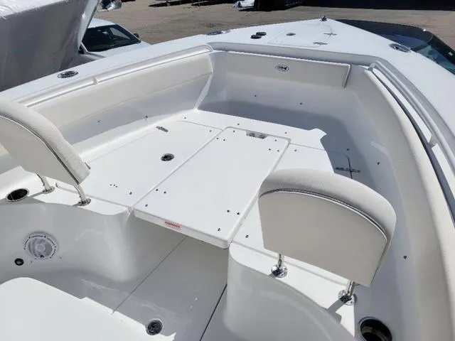 Slide: The Image of 2024 Sea Hunt Gamefish 25 boat interior with white seating and deck. - 14