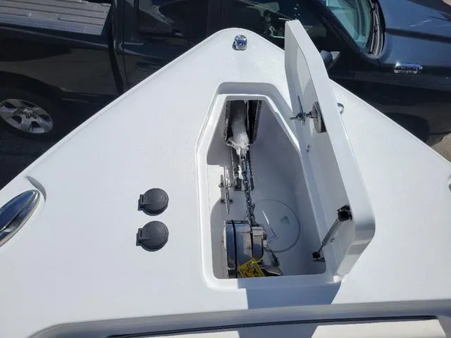 Slide: The Image of 2024 Sea Hunt Gamefish 25 boat anchor compartment with open hatch. - 15