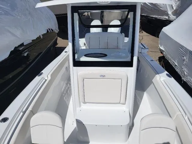 Slide: The Image of 2024 Sea Hunt Gamefish 25 boat interior with white seating and console. - 16