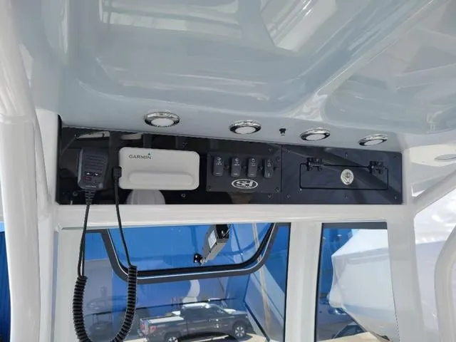 Slide: The Image of 2024 Sea Hunt Gamefish 25 boat console with Garmin electronics and control panel. - 18