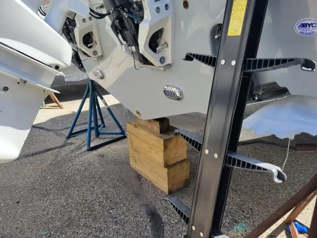 Slide: The Image of 2024 Sea Hunt Gamefish 25 boat on blocks, showing rear engine area. - 6