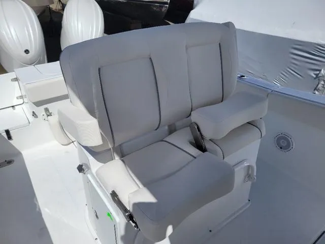 Slide: The Image of 2024 Sea Hunt Gamefish 25 boat seating with cushioned armrests and white upholstery. - 9