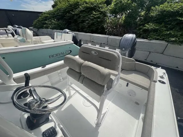 Slide: The Image of 2025 Sea Hunt Ultra 219 boat interior with steering wheel and seating. - 10