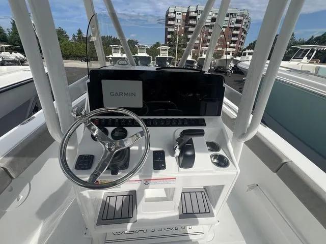 Slide: The Image of 2025 Sea Hunt Ultra 219 boat console with Garmin navigation system and steering wheel. - 11