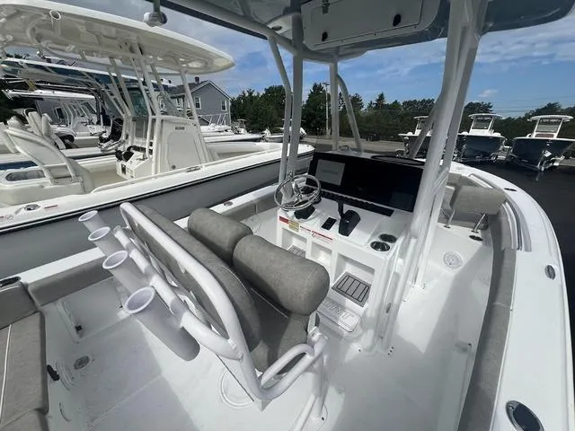 Slide: The Image of 2025 Sea Hunt Ultra 219 boat interior with helm, seating, and rod holders. - 17