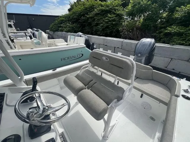 Slide: The Image of 2025 Sea Hunt Ultra 219 boat interior with steering wheel and seating. - 9