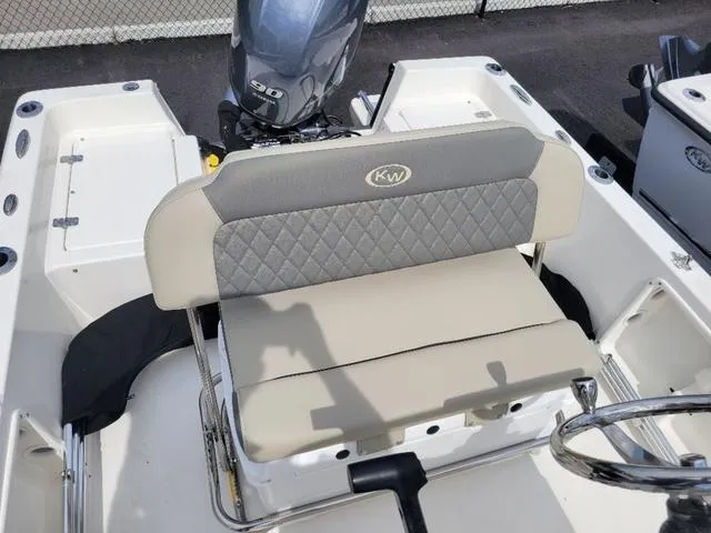 Slide: The Image of 2025 Key West 1720 CC boat with cushioned seating and outboard motor. - 10
