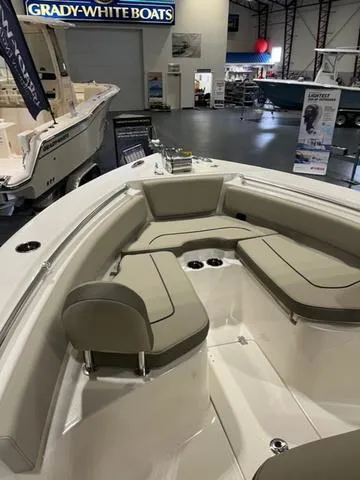 Slide: The Image of 2025 Key West 239 FS boat interior with cushioned seating in a showroom. - 8