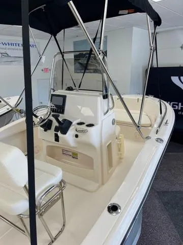Slide: The Image of 2025 Grady-White Fisherman 180 boat interior with console and seating, displayed indoors. - 11