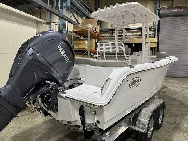 Slide: The Image of 2025 Sea Hunt Ultra 229 boat with Yamaha engine on a trailer in a warehouse. - 3