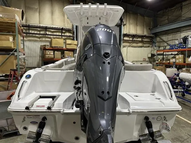 Slide: The Image of 2025 Sea Hunt Ultra 229 boat with powerful 200 HP engine in a warehouse setting. - 4