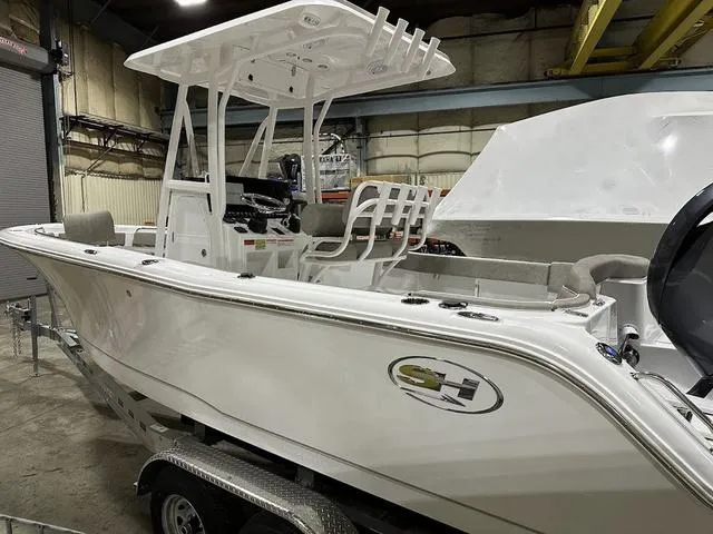 Slide: The Image of 2025 Sea Hunt Ultra 229 boat in a warehouse, featuring sleek design and modern amenities. - 5