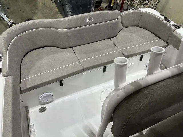 Slide: The Image of 2025 Sea Hunt Ultra 229 boat interior with cushioned seating and rod holders. - 6