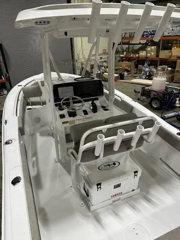 Slide: The Image of 2025 Sea Hunt Ultra 229 boat interior with console and rod holders. - 7