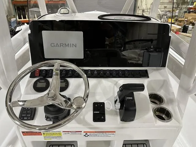 Slide: The Image of 2025 Sea Hunt Ultra 229 boat dashboard with Garmin navigation system and steering wheel. - 8