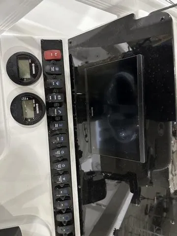 Slide: The Image of 2025 Sea Hunt Ultra 229 dashboard with controls and display screen. - 9