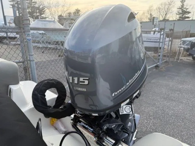 Slide: The Image of 2025 Key West 189 FS boat with Yamaha 115 outboard motor in a marina setting. - 10