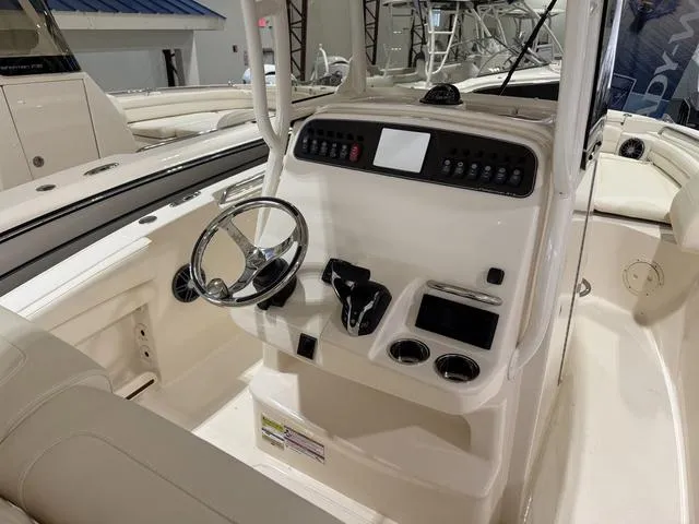Slide: The Image of 2025 Grady-White Fisherman 216 boat console with steering wheel and controls. - 5