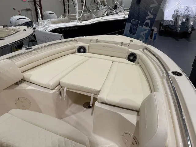 Slide: The Image of 2025 Grady-White Fisherman 216 boat interior with cushioned seating and speakers. - 7
