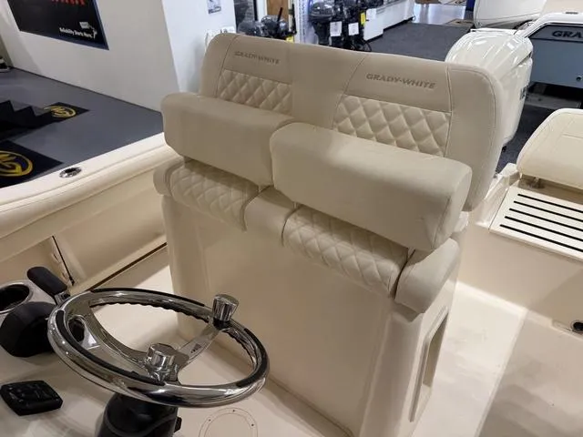 Slide: The Image of 2025 Grady-White Fisherman 216 boat interior with plush seating and steering wheel. - 9