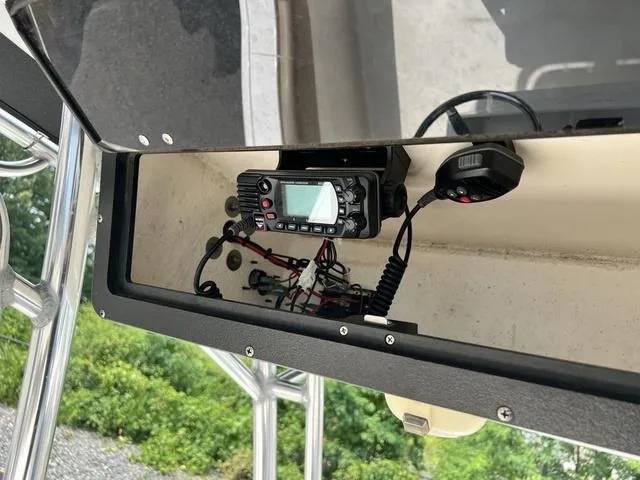 Slide: The Image of 2019 Key West 239FS boat console with radio equipment and wiring. - 11