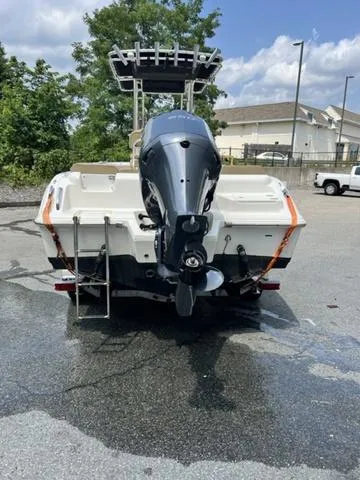 Slide: The Image of 2019 Key West 239FS boat with outboard motor, parked on wet pavement. - 3