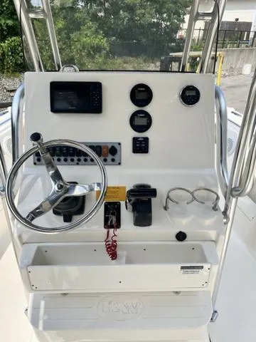 Slide: The Image of 2019 Key West 239FS boat dashboard with steering wheel and navigation controls. - 5