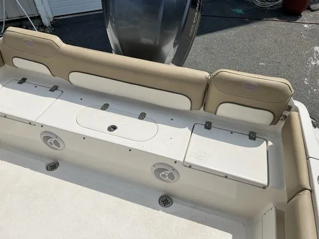 Slide: The Image of 2019 Key West 239FS boat interior with beige seating and storage compartments. - 6