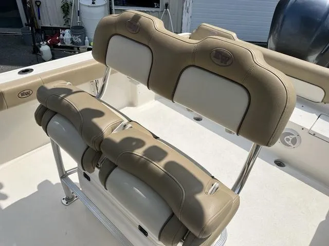 Slide: The Image of 2019 Key West 239FS boat seating with tan upholstery and stainless steel frame. - 7