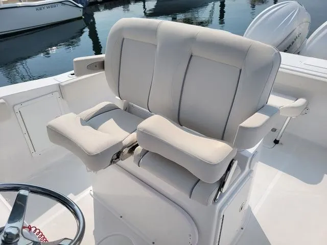 Slide: The Image of 2024 Sea Hunt Gamefish 27 boat with forward seating and dual helm chairs. - 10