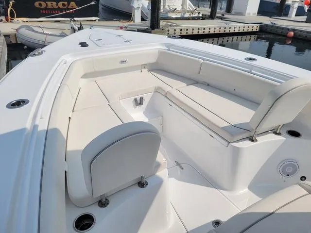 Slide: The Image of 2024 Sea Hunt Gamefish 27 boat with forward seating at a marina. - 11