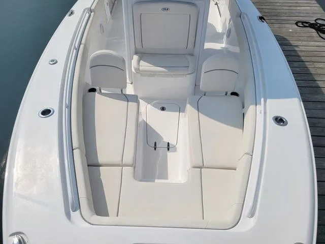 Slide: The Image of 2024 Sea Hunt Gamefish 27 boat with forward seating, docked, showcasing spacious white interior. - 12