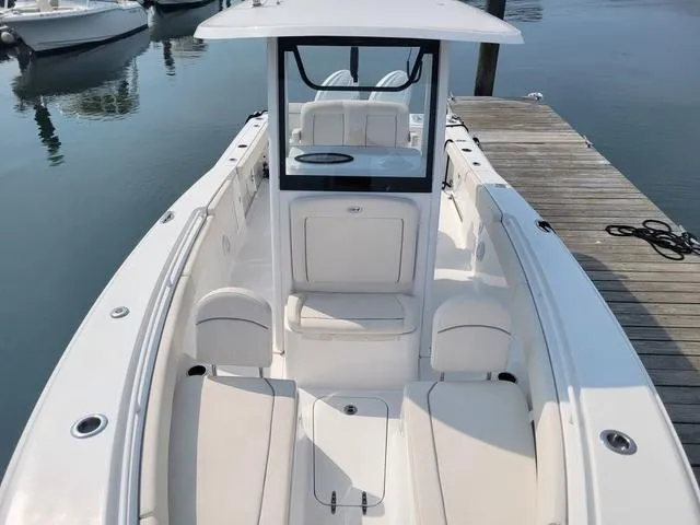 Slide: The Image of 2024 Sea Hunt Gamefish 27 with Forward Seating, docked, showcasing spacious interior and sleek design. - 13