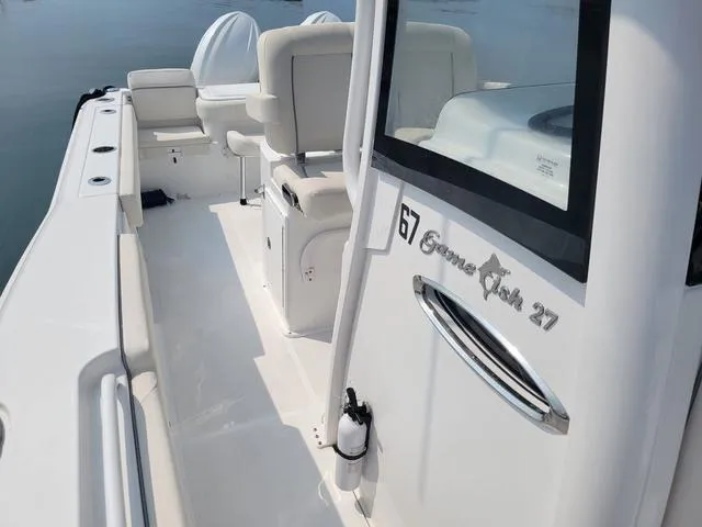 Slide: The Image of 2024 Sea Hunt Gamefish 27 boat with forward seating, showcasing sleek design and spacious interior. - 14