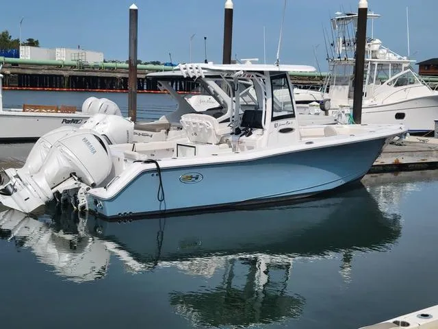 Slide: The Image of 2024 Sea Hunt Gamefish 27 with Forward Seating docked in marina. - 3