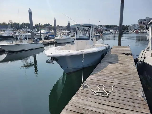 Slide: The Image of 2024 Sea Hunt Gamefish 27 boat docked with forward seating, in a marina setting. - 4