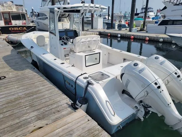 Slide: The Image of 2024 Sea Hunt Gamefish 27 boat with forward seating docked at marina. - 5