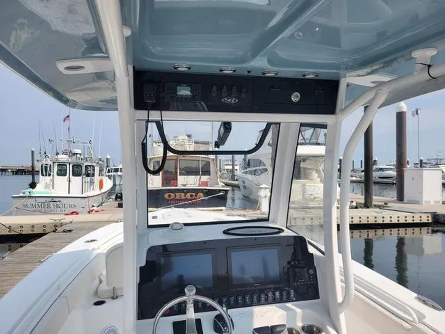 Slide: The Image of 2024 Sea Hunt Gamefish 27 boat interior with advanced navigation system at marina. - 8