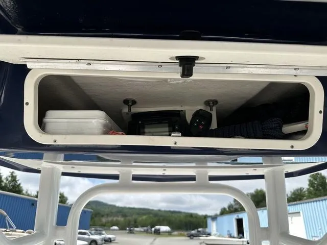Slide: The Image of Storage compartment on a 2022 Robalo R242 boat, containing equipment and supplies. - 13