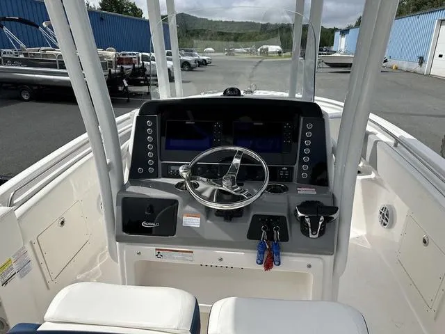 Slide: The Image of 2022 Robalo R242 boat dashboard with steering wheel and control panel. - 23