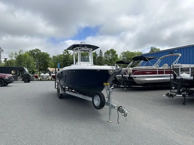 Slide: The Image of 2022 Robalo R242 boat on trailer in outdoor dealership lot. - 3