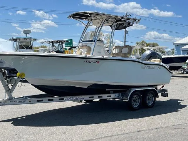 Slide: The Image of 2020 Key West 219fs boat on trailer under clear blue sky. - 1