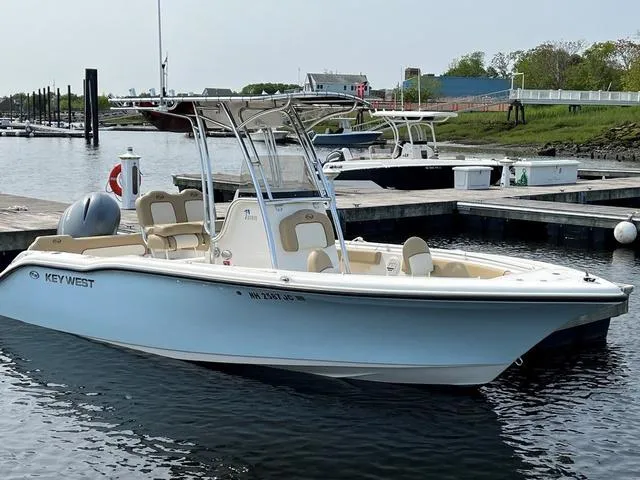Slide: The Image of 2020 Key West 219fs boat docked at marina, calm water, clear sky. - 11